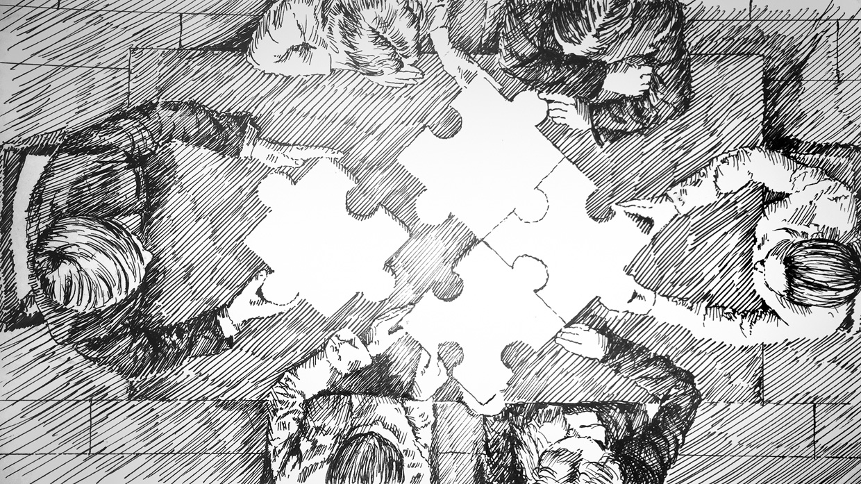 Persons work together to solve a puzzle.